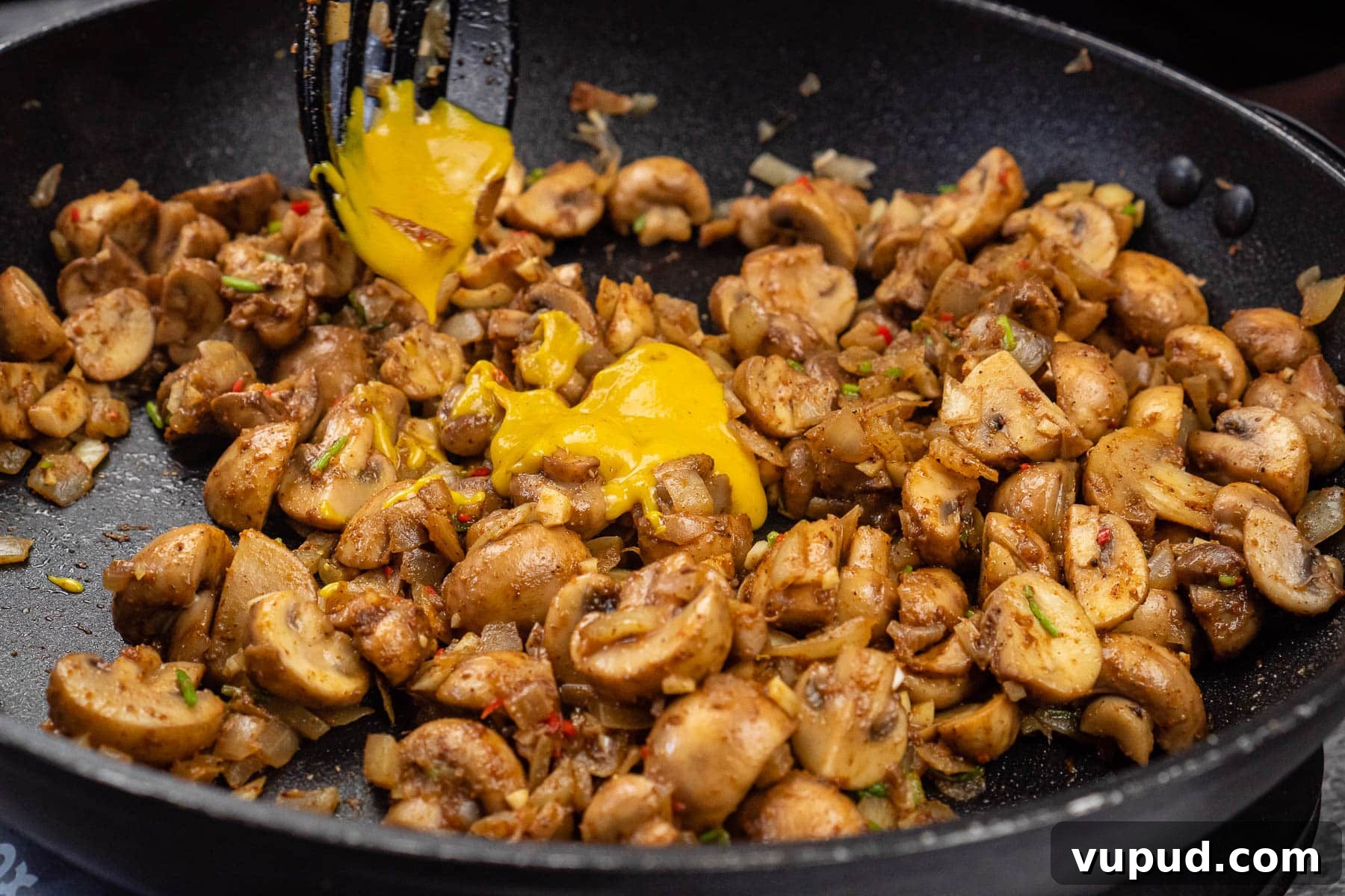 Indian Mushroom Bhaji Recipe: Flavorful Mushroom Curry Guide 19 English mustard being added to the mushroom bhaji cooking in a frying pan