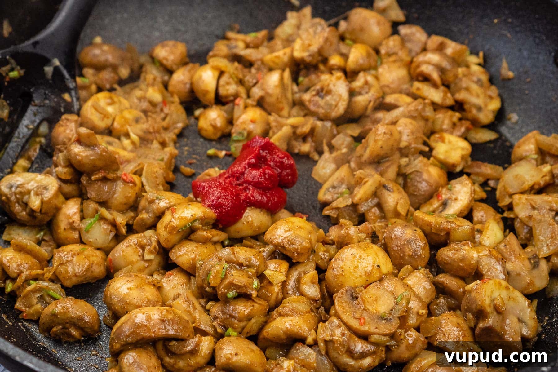 Indian Mushroom Bhaji Recipe: Flavorful Mushroom Curry Guide 21 Tomato puree added to the mushroom bhaji cooking in a frying pan