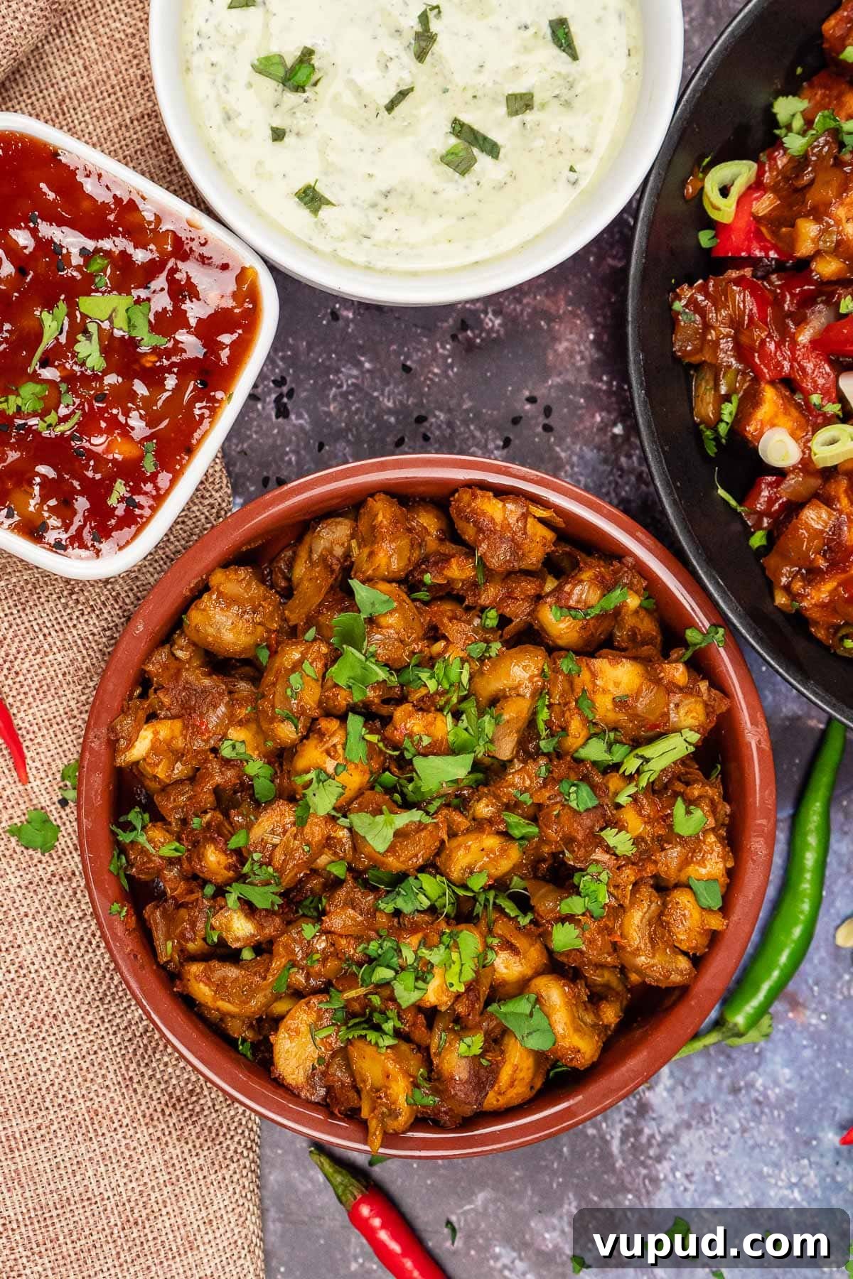Indian Mushroom Bhaji Recipe: Flavorful Mushroom Curry Guide 24 Mushroom Bhaji served in a side dish with mango chutney, mint raita and chilli paneer around the tapas dish