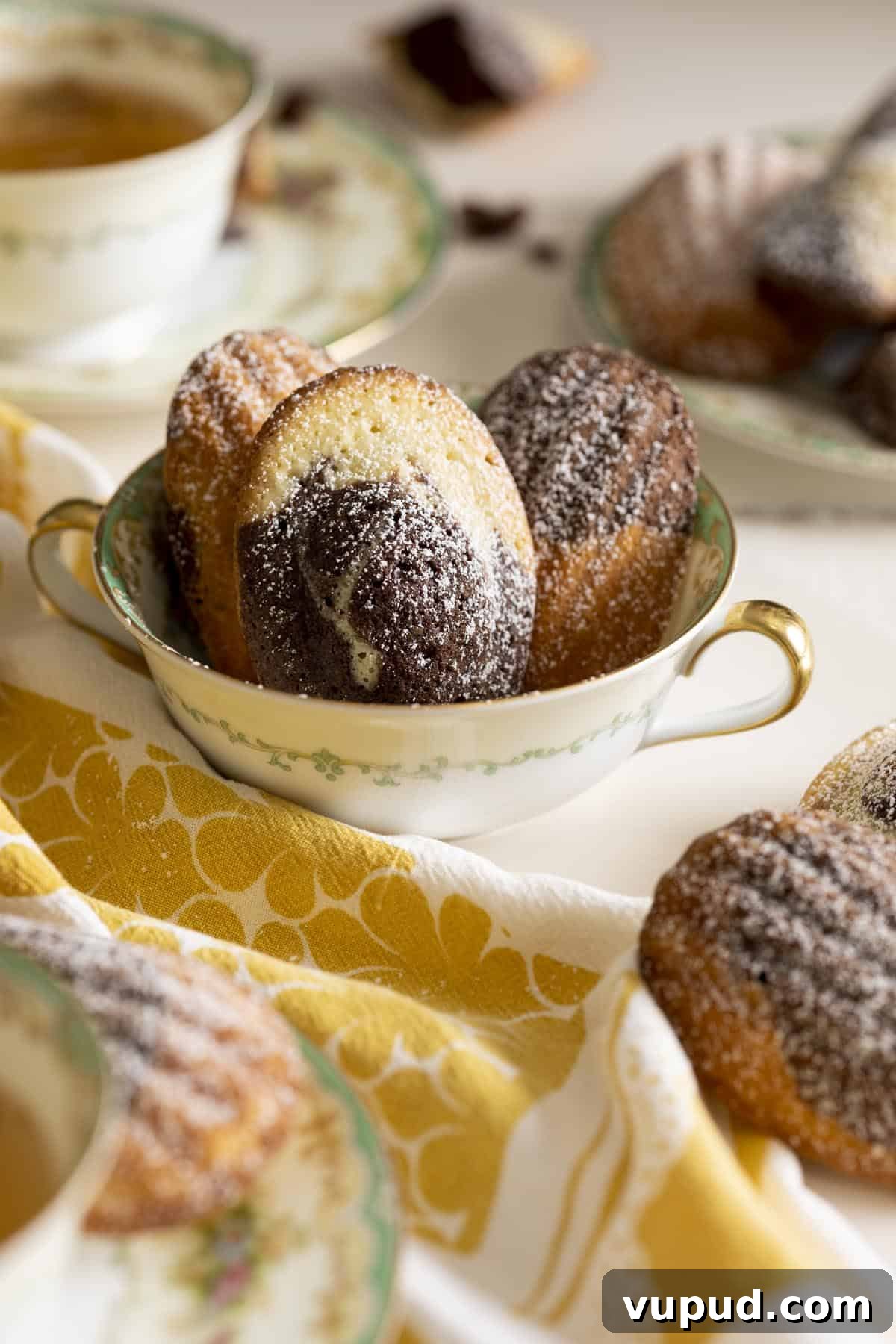 Chocolate Vanilla Marble Madeleines: Swirled French Tea Cakes 8 Three marble madeleines inside a tea cup.