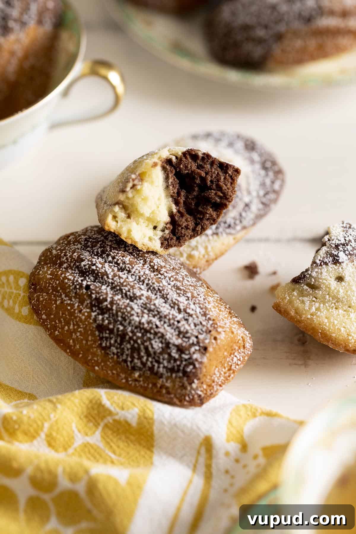 Chocolate Vanilla Marble Madeleines: Swirled French Tea Cakes 9 A chocolate and vanilla marble madeleine broken in half showing the marble texture.