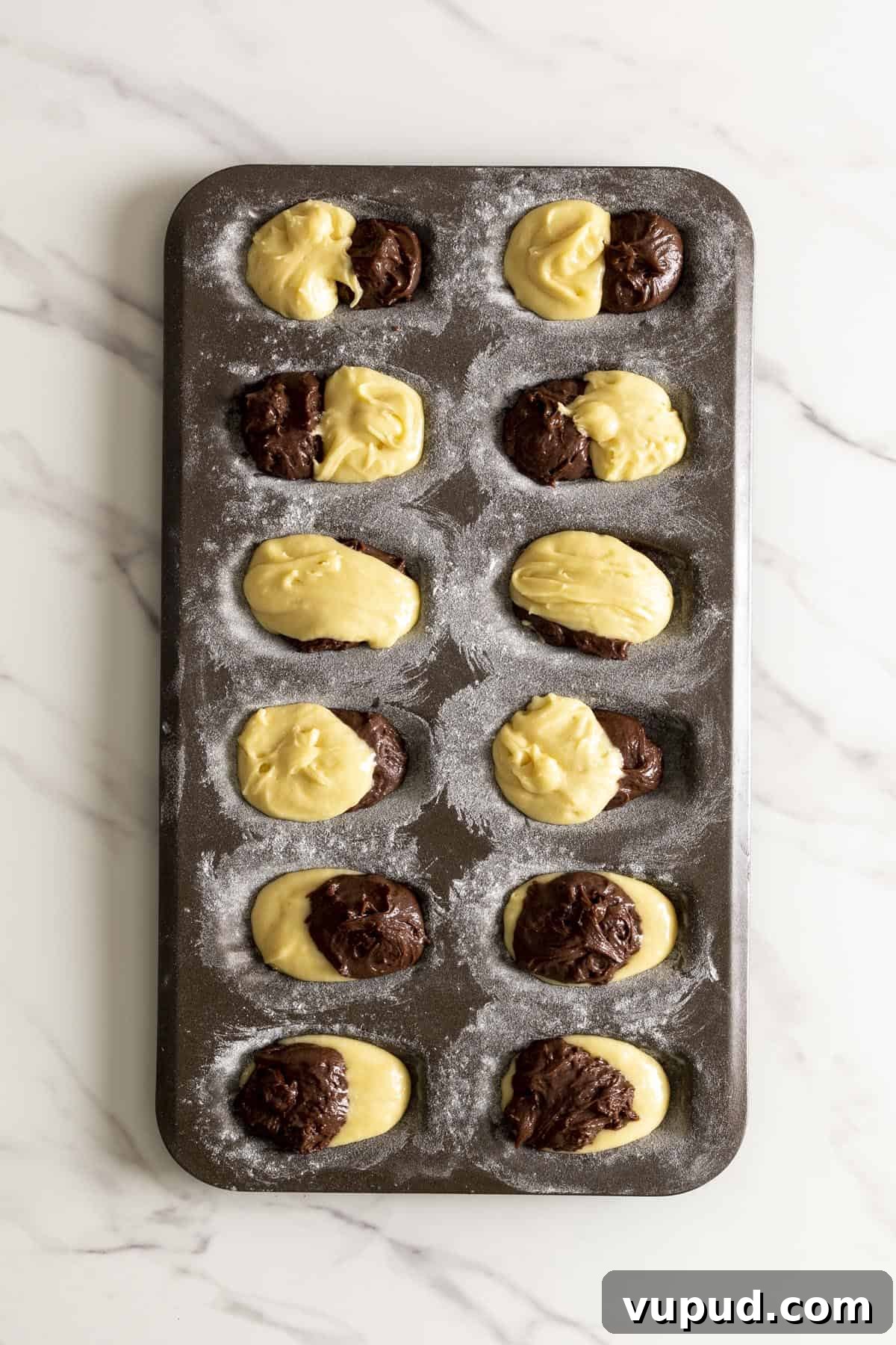Chocolate Vanilla Marble Madeleines: Swirled French Tea Cakes 6 Marble madeleine batter in a madeleine pan.