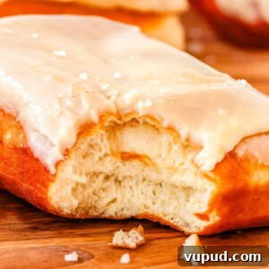 Classic Maple Bar Donut Recipe: Soft, Glazed, and Irresistible 11 A bite taken out of the maple bar donut so you can see the soft, chewy, and pillowy interior.