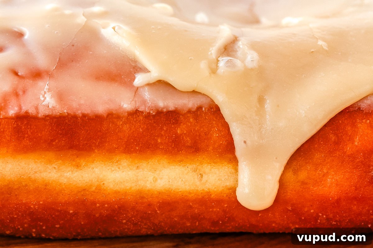 Classic Maple Bar Donut Recipe: Soft, Glazed, and Irresistible 10 A close up of a maple long John with the maple glaze dripping off the donut.