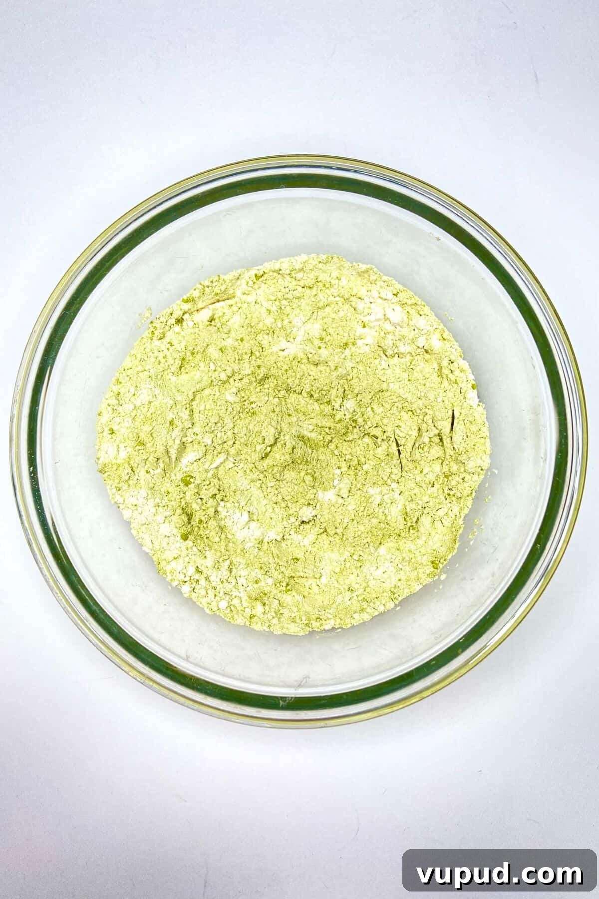 Matcha Crinkle Cookies Recipe: Soft, Chewy Green Tea Cookies 5 Flour, matcha powder, and baking powder mixed together in a glass bowl.