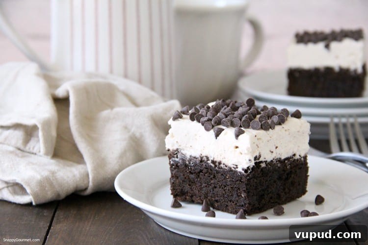 Cannoli Brownies - bakery style brownie recipe Cannoli Brownie with frosting and chocolate chips on plate