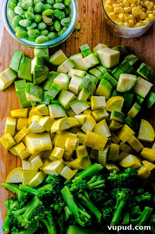 Veggie-Packed Quinoa Fried Rice Recipe for Flavorful Meals 3 Chopped zucchini, yellow squash and broccoli on a wood cutting bard