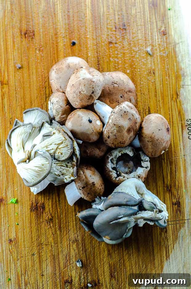 Veggie-Packed Quinoa Fried Rice Recipe for Flavorful Meals 4 assorted mushrooms on a wood cutting board