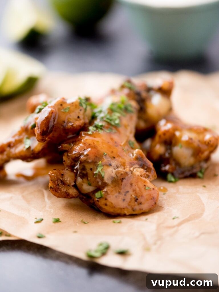 Tequila-Lime Chicken Wings: Zesty Grilled Wing Recipe 2 Tequila lime chicken wings laying on parchment paper.