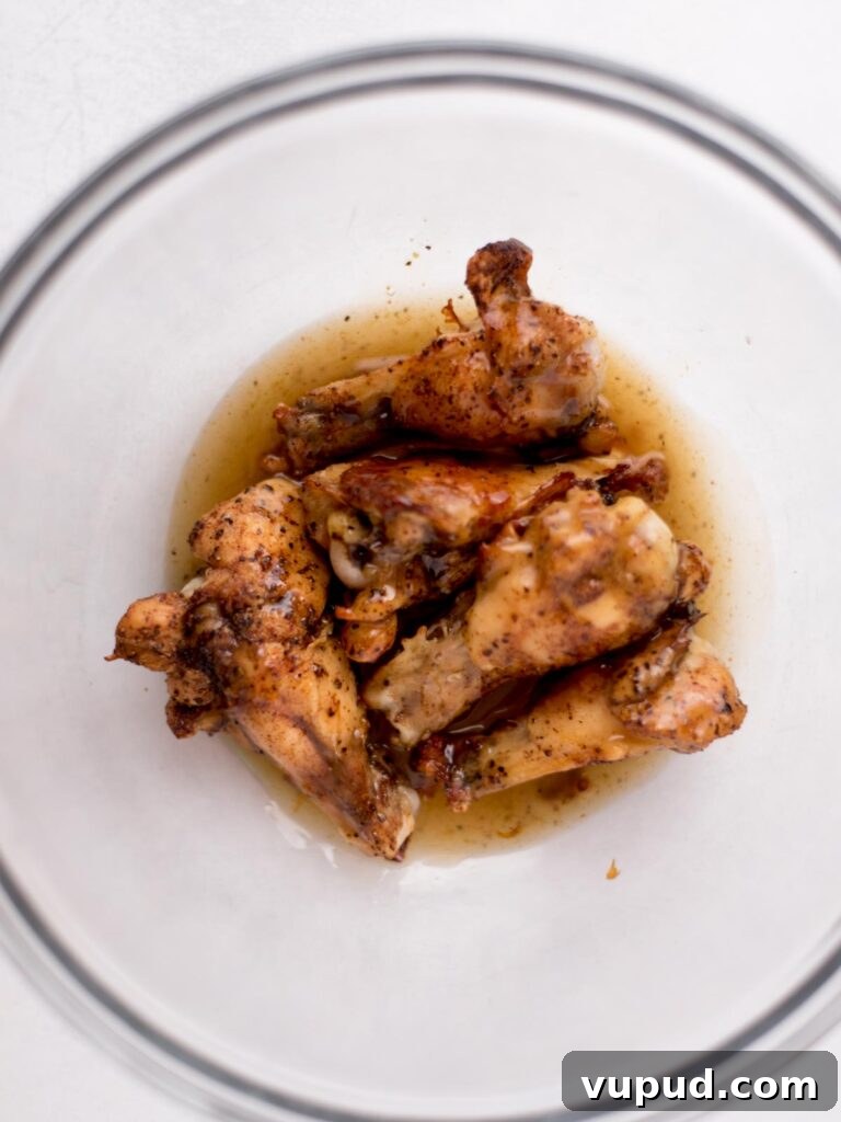 Tequila-Lime Chicken Wings: Zesty Grilled Wing Recipe 9 Baked chicken wings in a bowl with a tequila glaze.