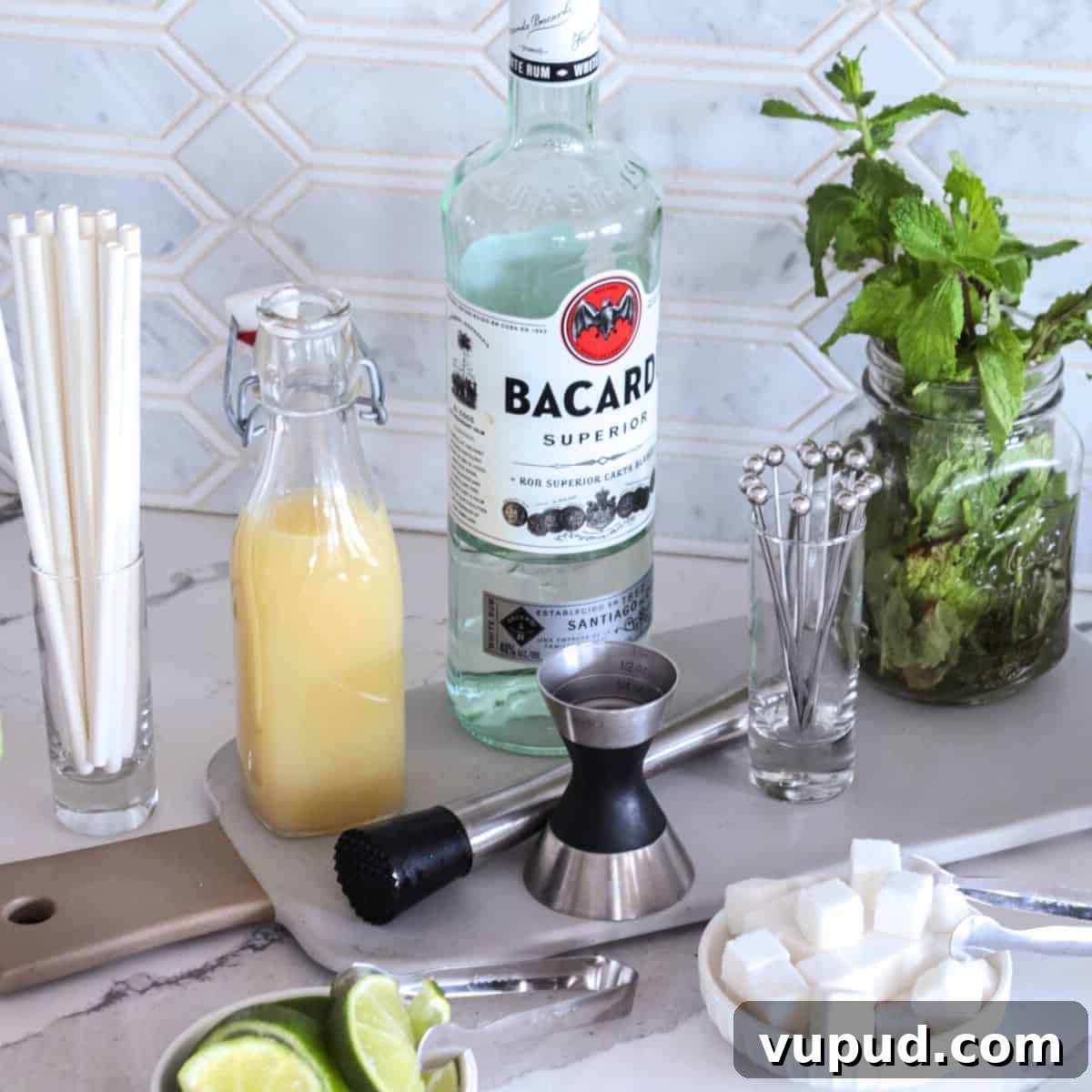 Mint Mojito Bar Ideas for Parties: DIY Setup & Refreshing Recipes 12 Moijito bar set-up with rum, mint, lime juice and sugar cubes.