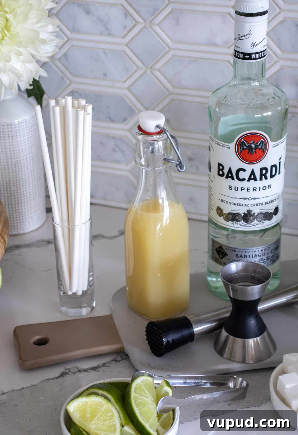 Mint Mojito Bar Ideas for Parties: DIY Setup & Refreshing Recipes 5 Rum and lime juice in a container for mojito bar.