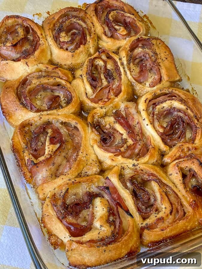 Quick Ham and Cheese Roll-Ups: 4-Ingredient Party Snack 16 Smaller crescent roll ham roll-ups baked with brown sugar poppyseed topping
