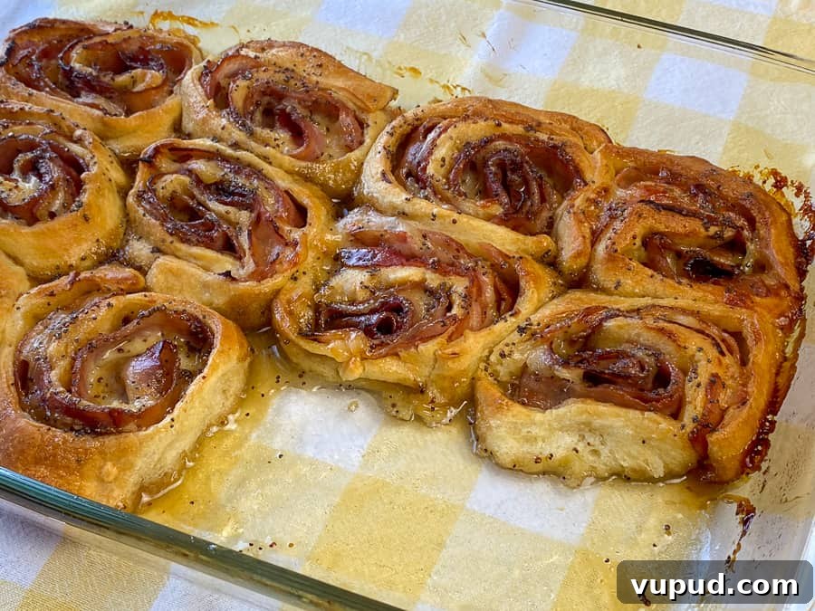 Quick Ham and Cheese Roll-Ups: 4-Ingredient Party Snack 5 Center of pan showing glazed and baked ham and cheese roll-ups