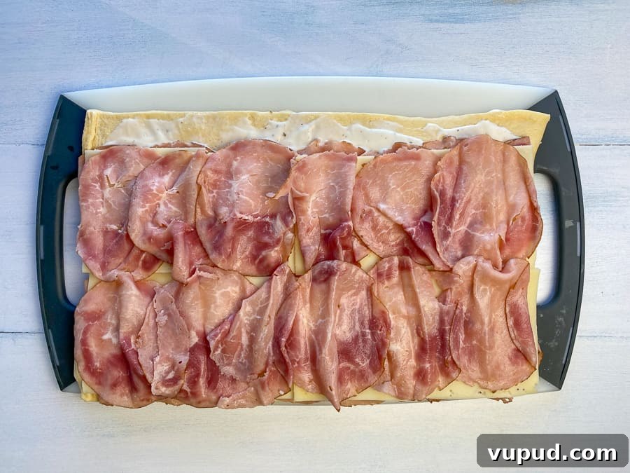 Quick Ham and Cheese Roll-Ups: 4-Ingredient Party Snack 9 Another layer of ham added on top of Swiss for ham roll-up