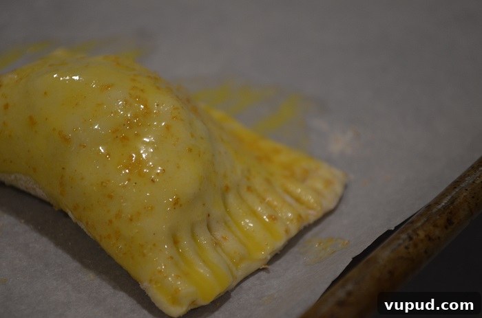 Crispy Beef Samosa Puff Pastries: Flaky Indian-Inspired Bites 24 cover completely in egg wash