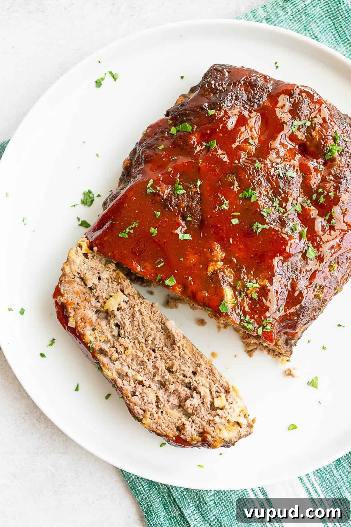 Classic Homemade Beef Meatloaf Recipe for Comforting Dinners 2 Classic Beef Meatloaf on a serving platter with a slice cut.