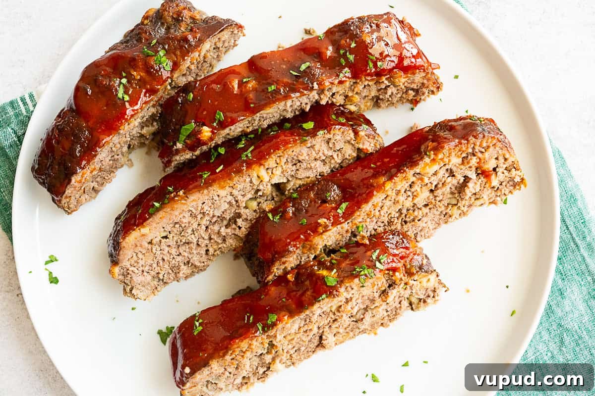 Classic Homemade Beef Meatloaf Recipe for Comforting Dinners 6 Classic Beef Meatloaf sliced on a white serving plate.
