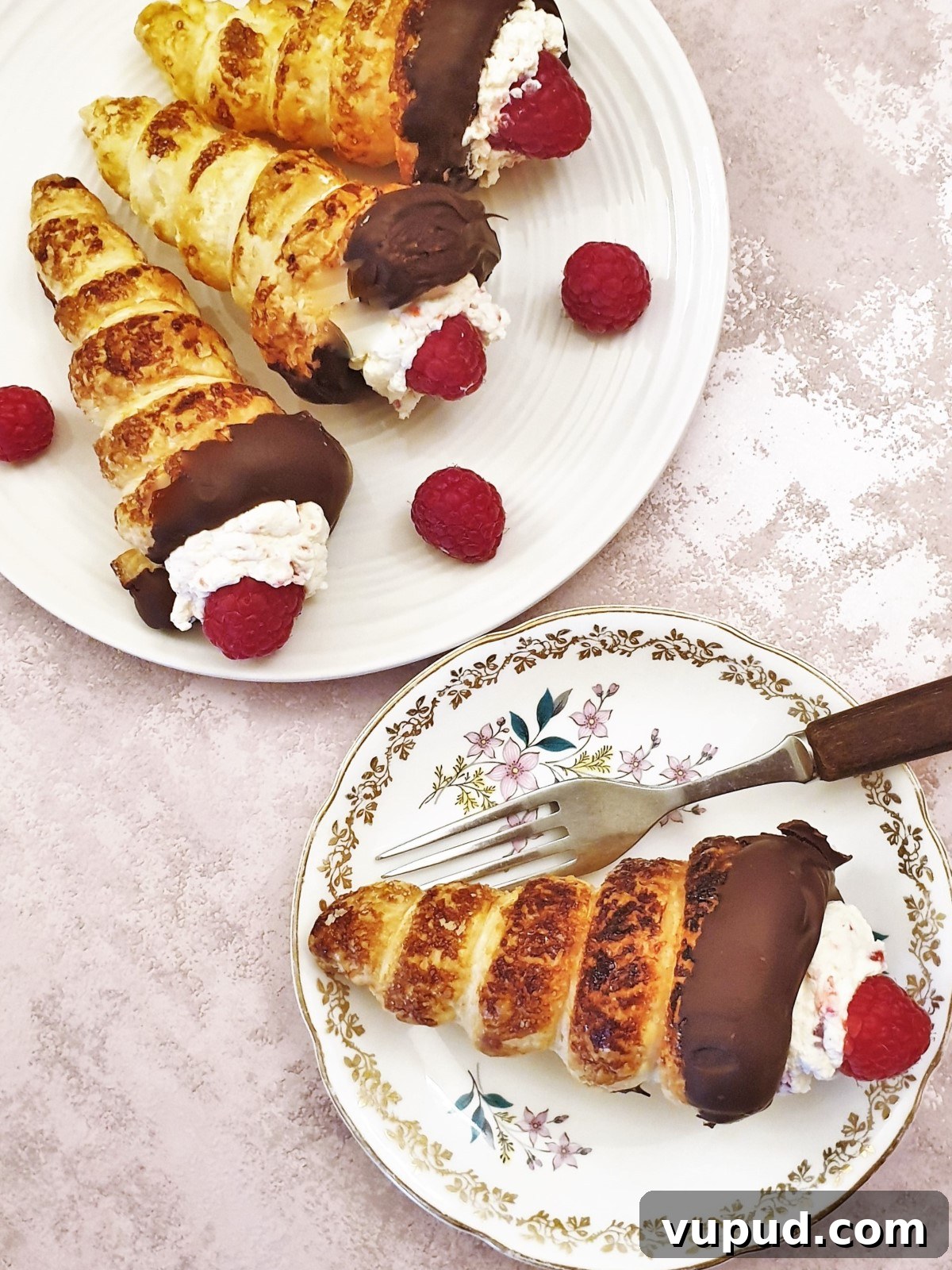 Overhead shot of 3 raspberry cream horns. Overhead shot of 3 raspberry cream horns.