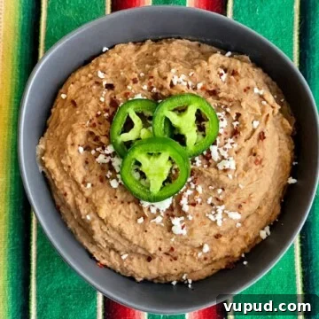Authentic Mexican-Style Beans in the Instant Pot: Flavorful & Fast 11 instant pot refried beans in a bowl with jalapenos on top