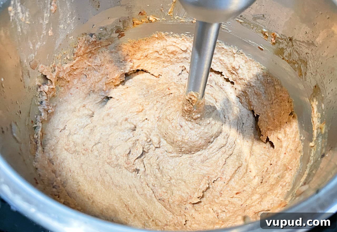 Authentic Mexican-Style Beans in the Instant Pot: Flavorful & Fast 6 refried beans being pureed in the instant pot.