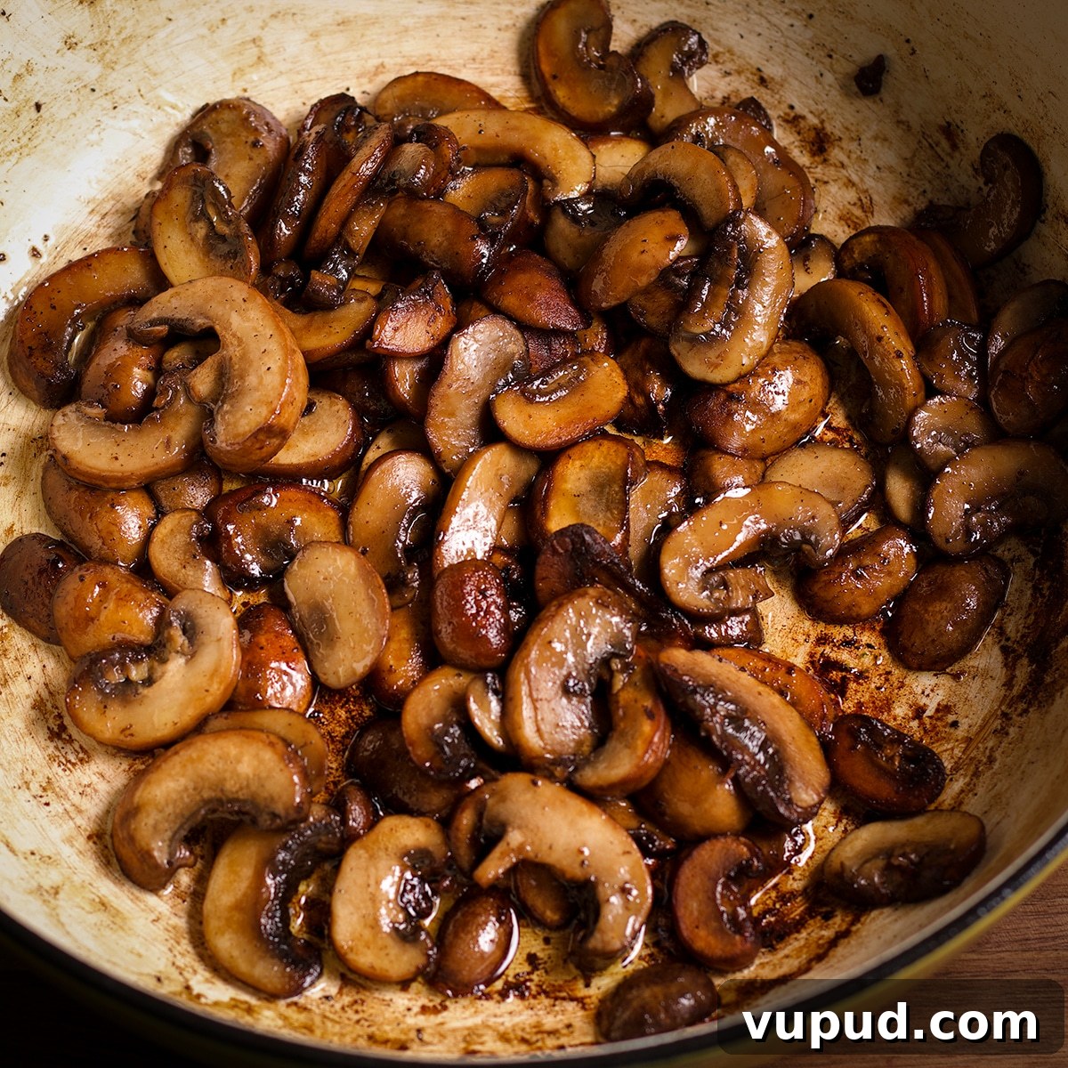 Chicken, Apples & Mushrooms in Cider Cream Sauce 6 Sliced mushrooms cooking in a pan.