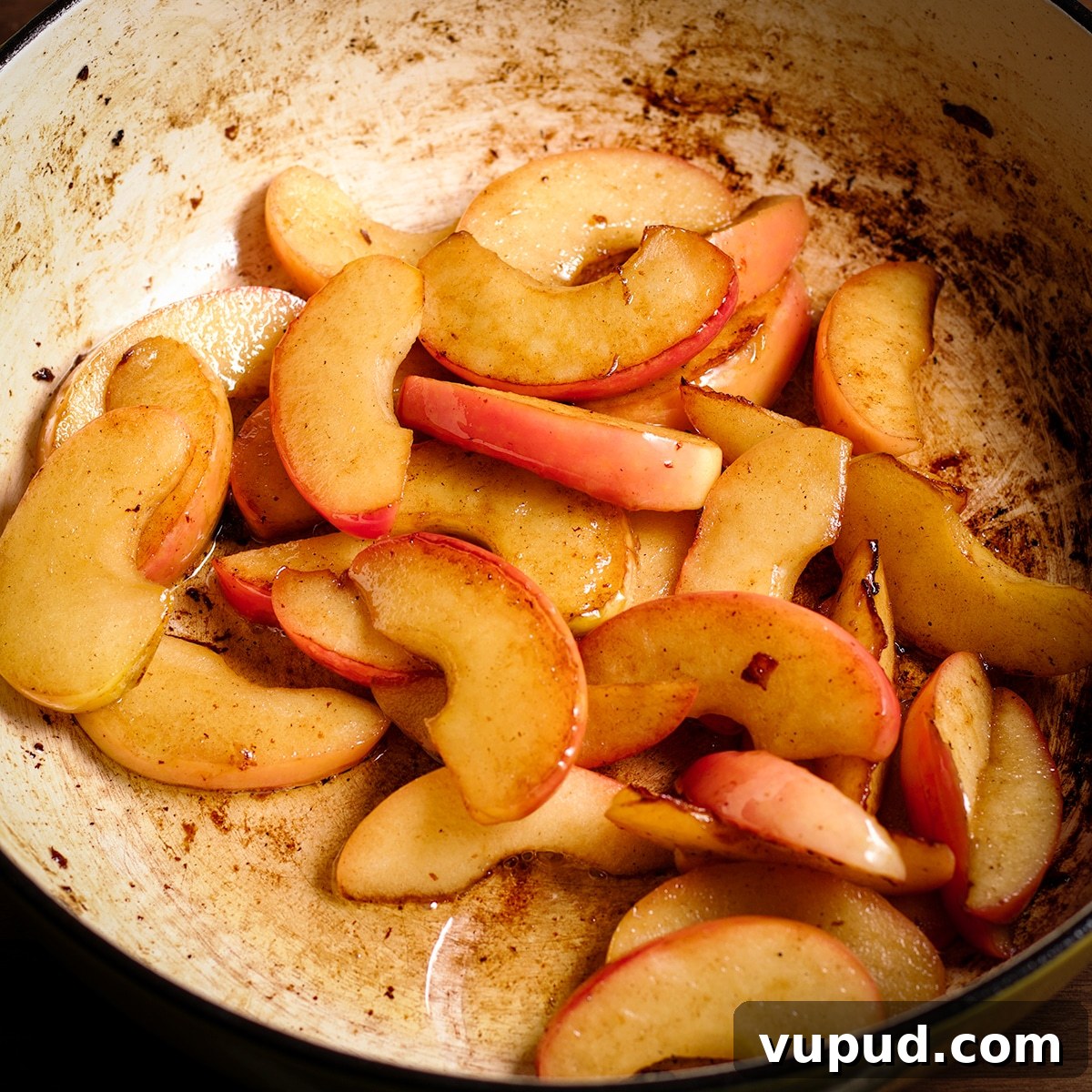 Chicken, Apples & Mushrooms in Cider Cream Sauce 7 Sliced apples cooking in butter in a pan.