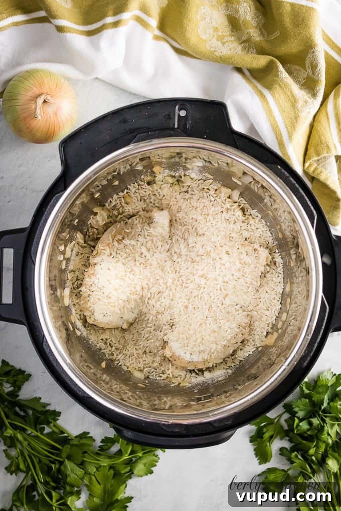 Instant Pot Ranch Chicken & Rice Casserole Recipe 4 The uncooked rice has been added to the pressure cooker.