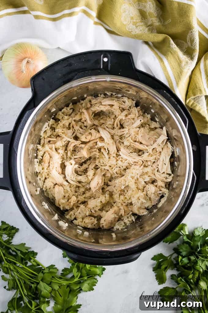 Instant Pot Ranch Chicken & Rice Casserole Recipe 6 The lid has been removed and the chicken breast has been shredded.