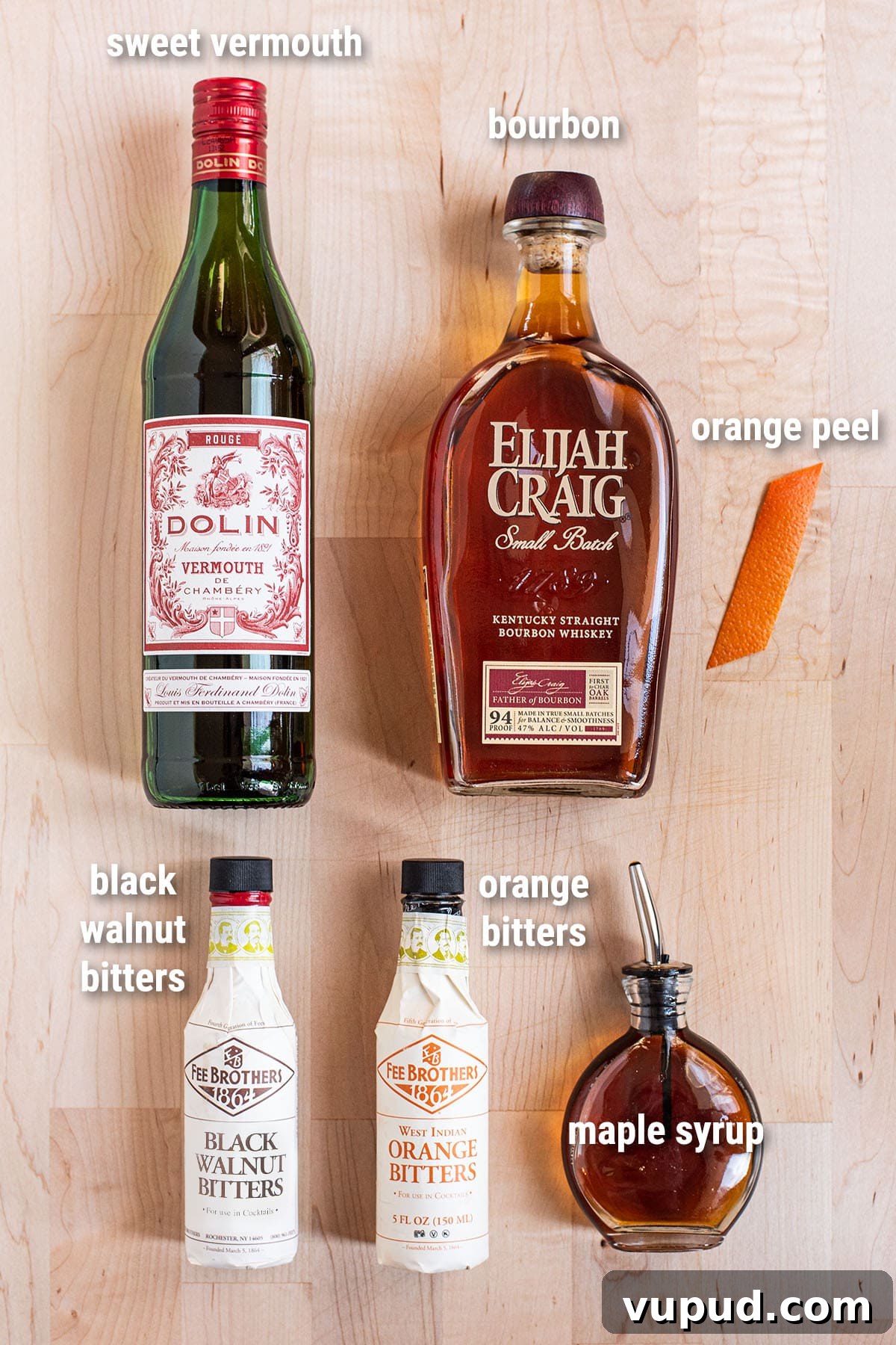 Maple Walnut Manhattan Cocktail Recipe & How to Mix One 2 Maple Walnut Manhattan cocktail ingredients laid out on a wooden cutting board.
