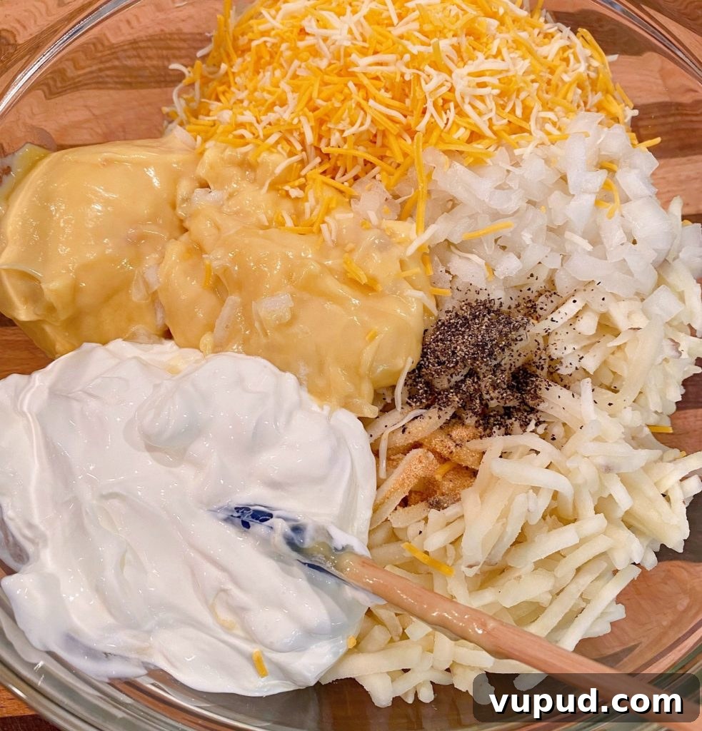 Cheesy Meatball and Hash Brown Casserole Recipe 6 Cheesy Hash Brown soup mixture in glass bowl.
