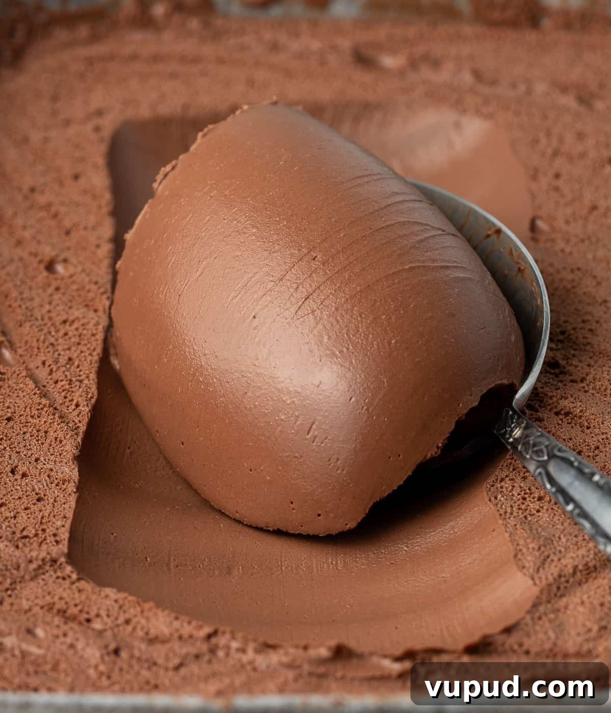 Namelaka: Silky Chocolate Cream Ganache Recipe and Guide 7 Close up on some cream scooped over a spoon.