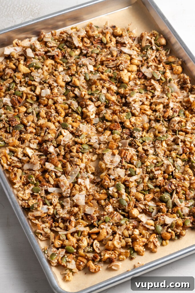 Grain-Free Homemade Granola Recipe for Crunchy, Low-Carb Mornings 11 grain free granola on a parchment lined cookie sheet before baking.