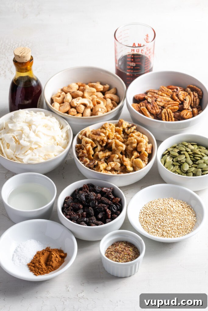 Grain-Free Homemade Granola Recipe for Crunchy, Low-Carb Mornings 5 ingredients needed to make grain free granola recipe measured out in bowls on a white table.