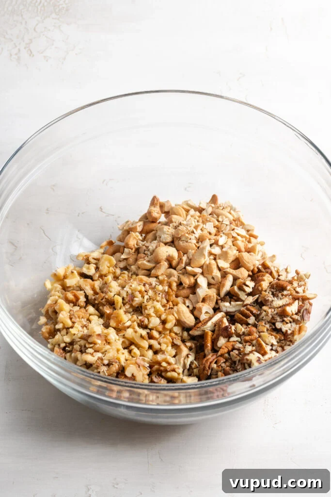 Grain-Free Homemade Granola Recipe for Crunchy, Low-Carb Mornings 6 chopped pecans, walnuts, and cashews in a bowl.