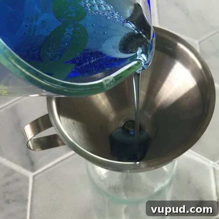 DIY Shower Cleaner Recipe for Sparkling, Streak-Free Tiles 4 Adding dish soap to bottle