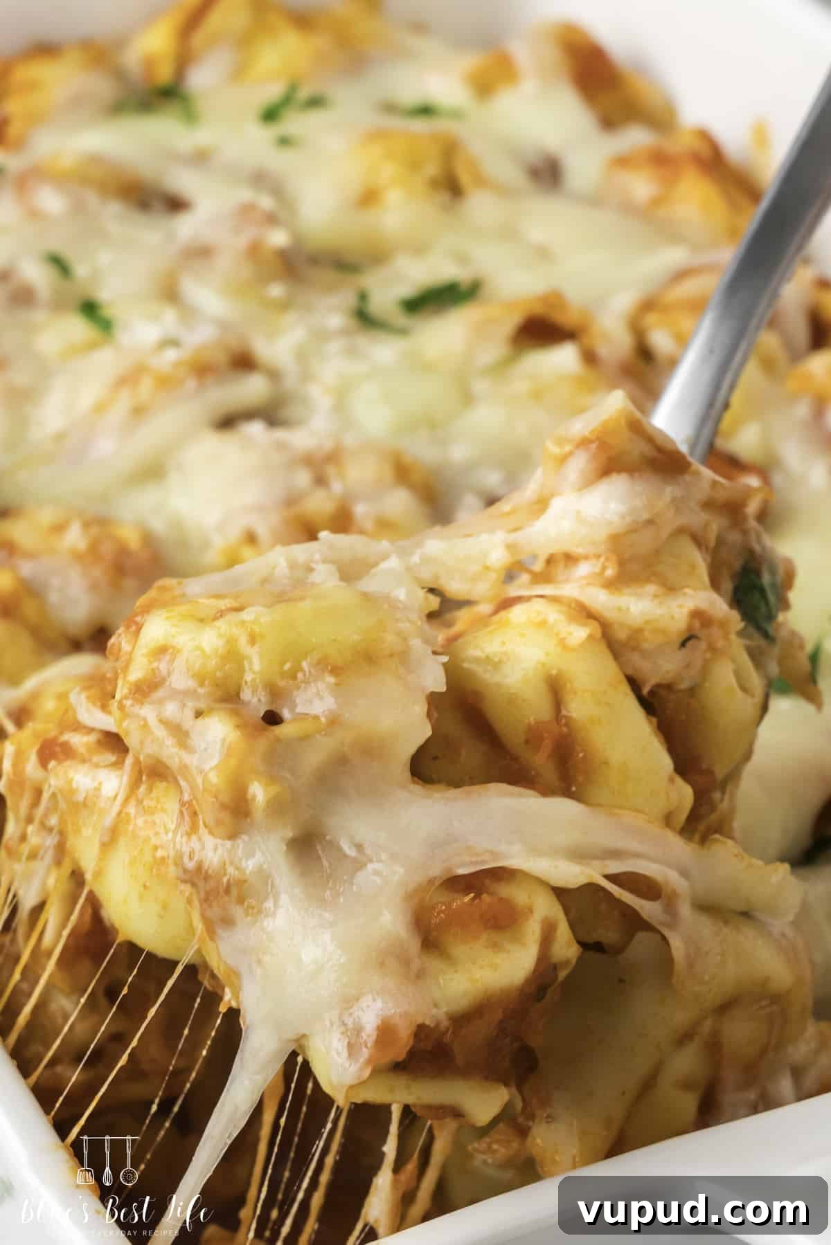 Cheesy Tortellini Casserole Bake with Garlic Parmesan Crust 8 A close-up shot of the tortellini pasta casserole with cheese pull.
