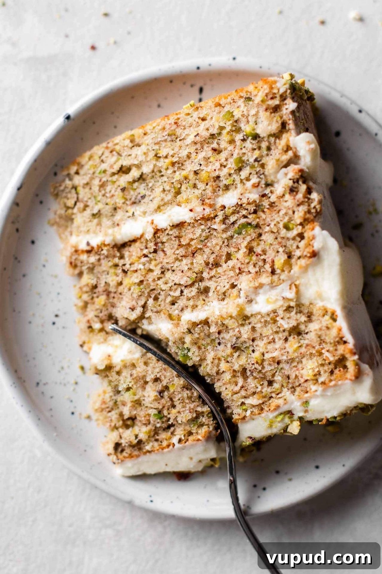 Silky Pistachio Layer Cake with Toasted Nut Crumble 13 slice of pistachio cake in plate
