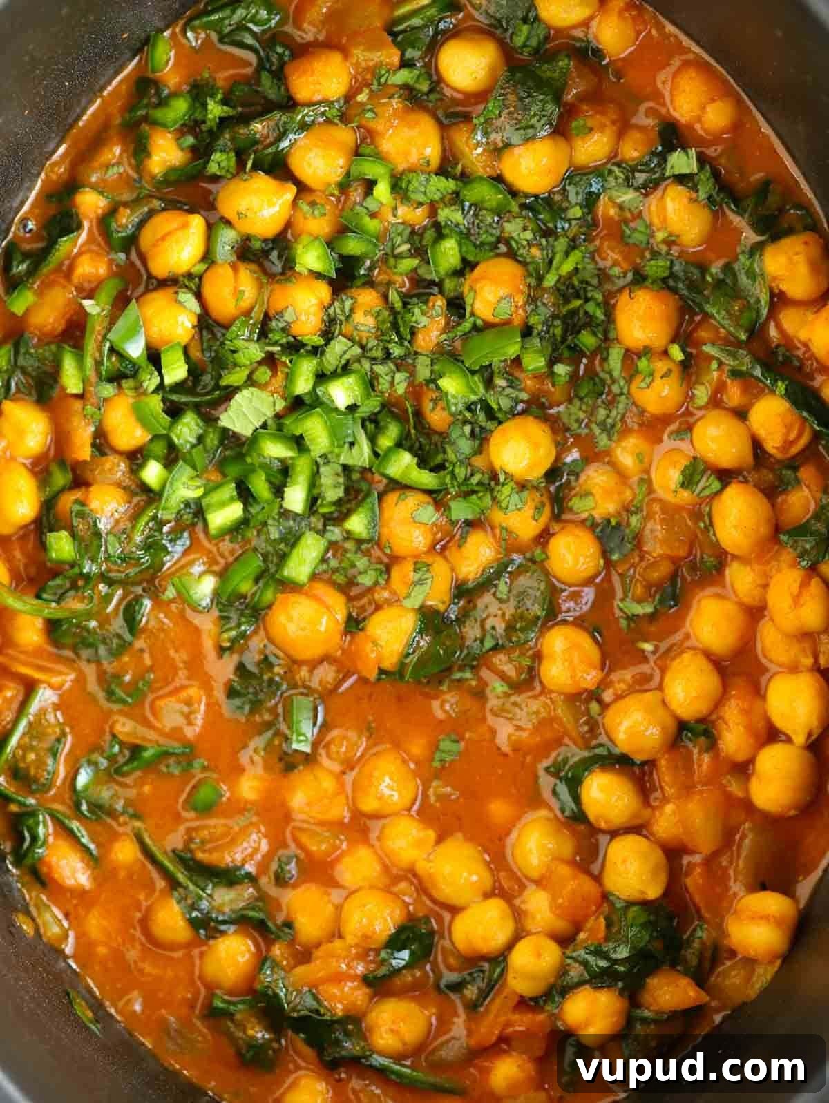 Slow-Cooked Chickpea and Spinach Curry (Chana Saag) 3 Close up of cooked curry with chickpeas.