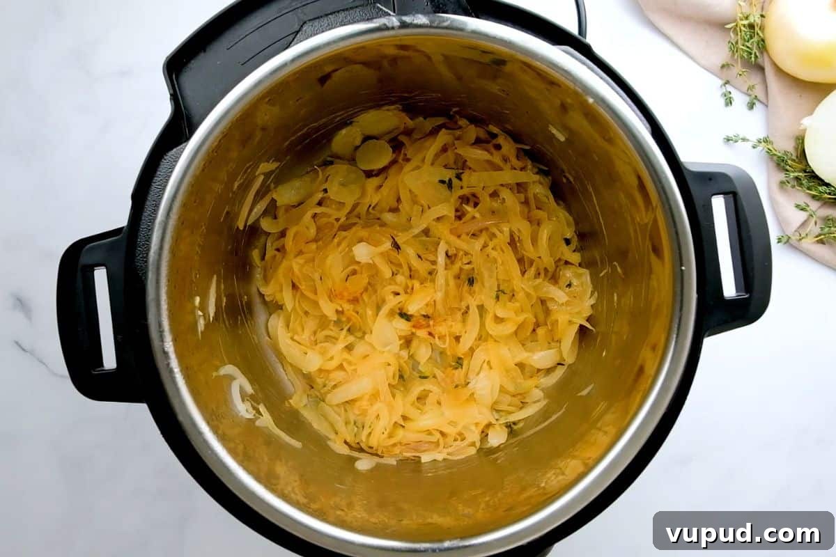 Pressure Cooker French Onion Soup Caramelized Onions inside inner pot after being sauteed in butter and olive oil with shallots and thyme.