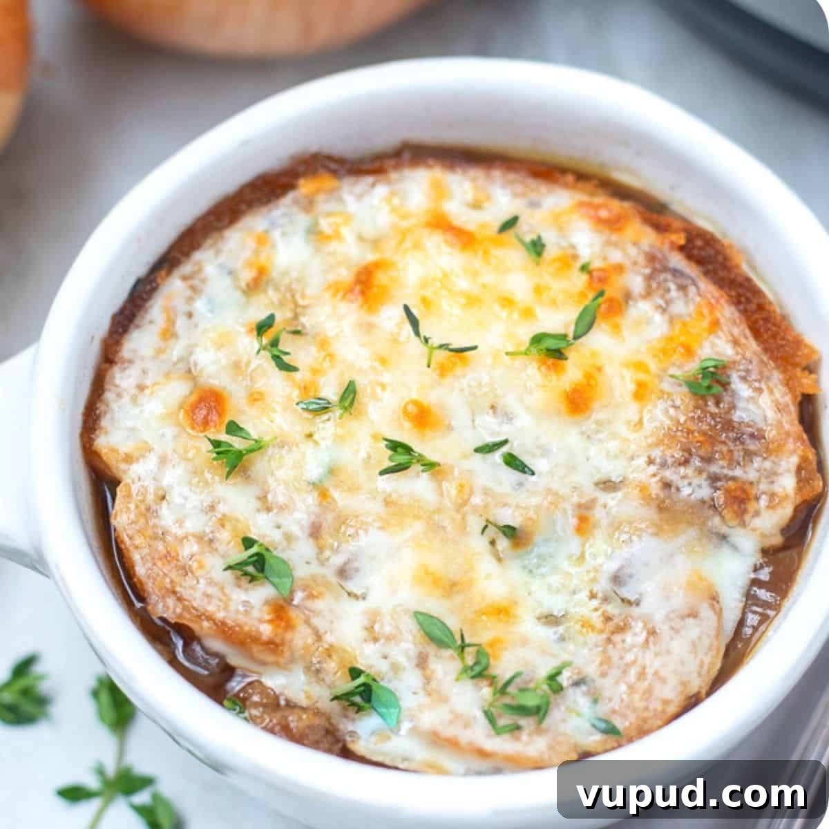 French Onion Soup Instant Pot Bowl of french onion soup topped with fresh thyme.
