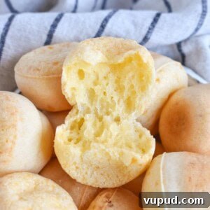 Fogo de Chão Pão de Queijo Recipe: How to Make Authentic Cheese Bread 9 cheese roll torn open top of bowl full of rolls.