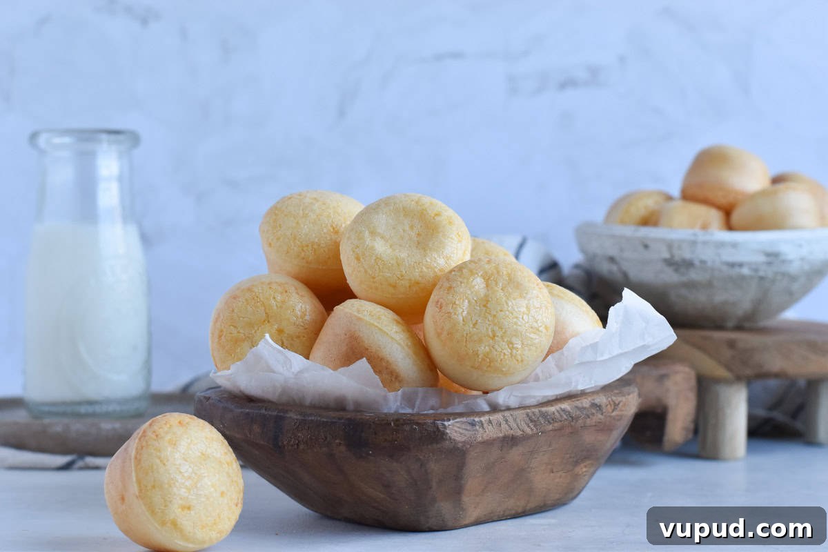 Fogo de Chão Pão de Queijo Recipe: How to Make Authentic Cheese Bread 7 brazilian cheese breads in wooden bowl.