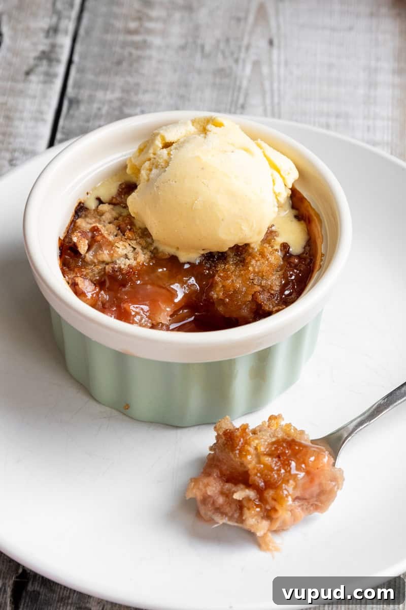 Classic Rhubarb Crumble Recipe with Golden Oat Topping 5 rhubarb crumble with a spoonful taken out
