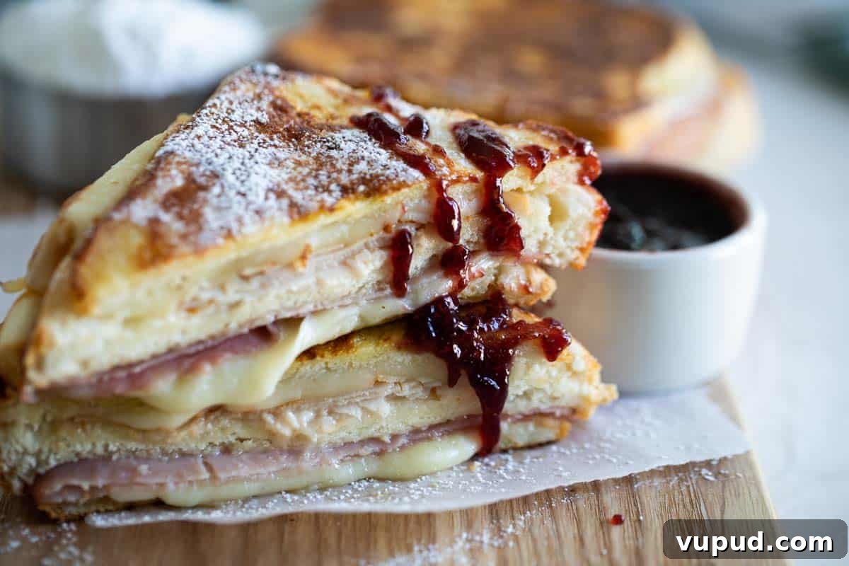 Monte Cristo Sandwich Monte Cristo Sandwich cut in half with jam drizzled on it