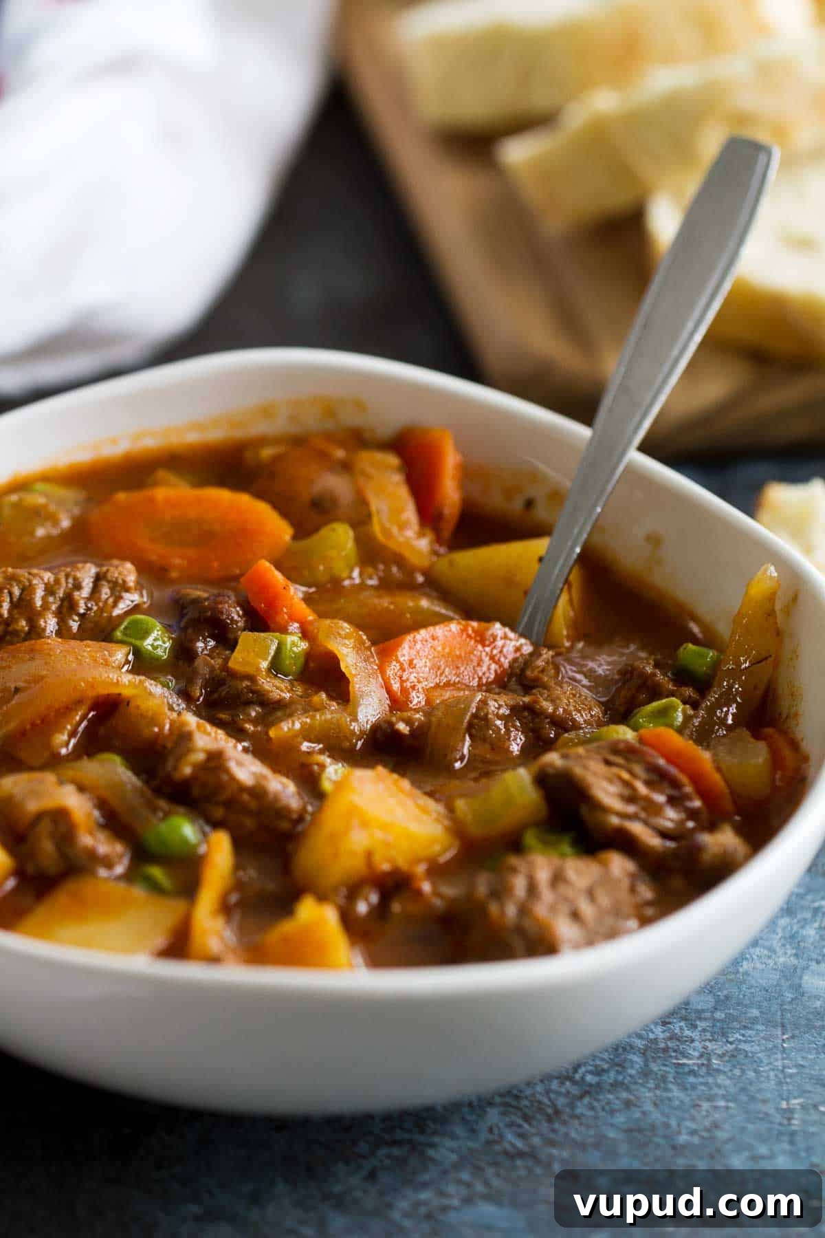 Homemade Beef Stew Bowl of Homemade Beef Stew with bread in the background