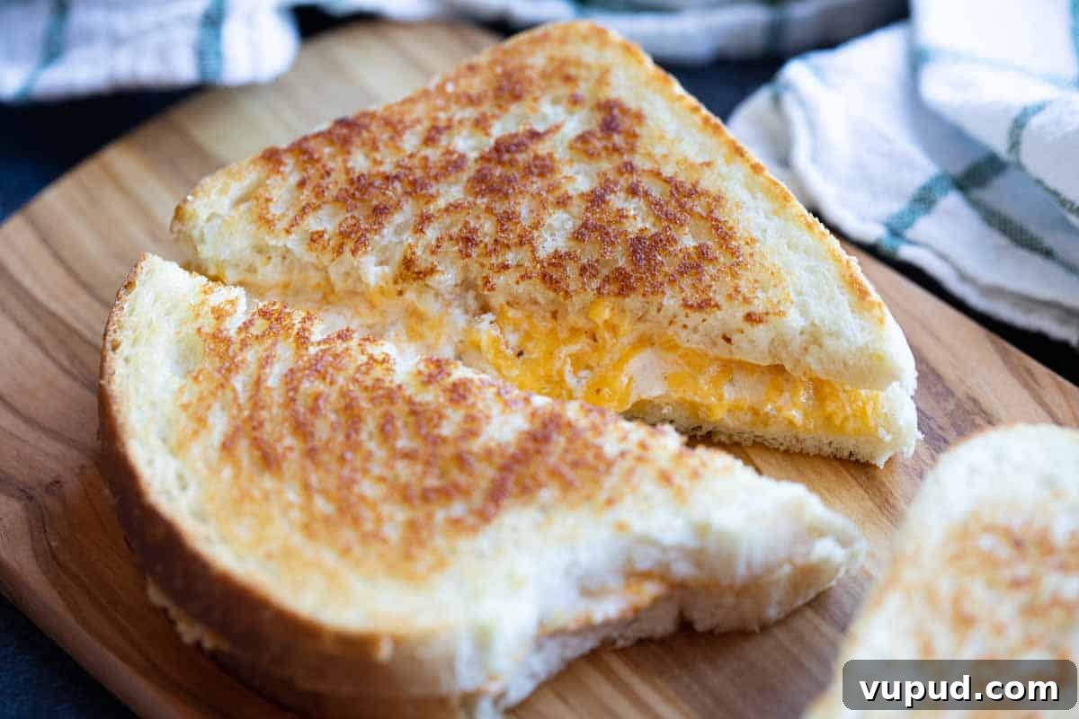 Grilled Cheese Sandwich sliced grilled cheese sandwich on a cutting board