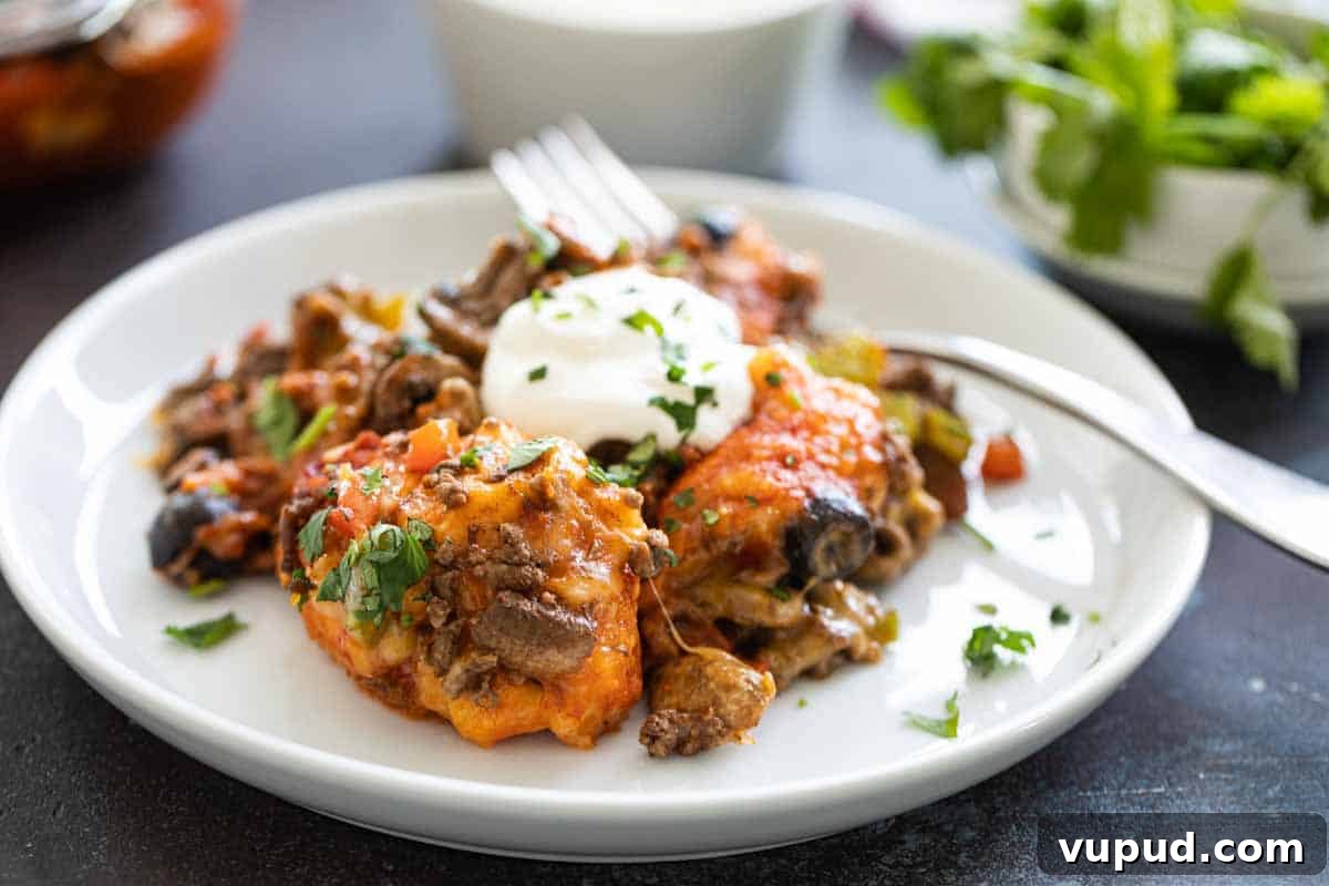 Taco Casserole taco casserole on a white plate with a fork
