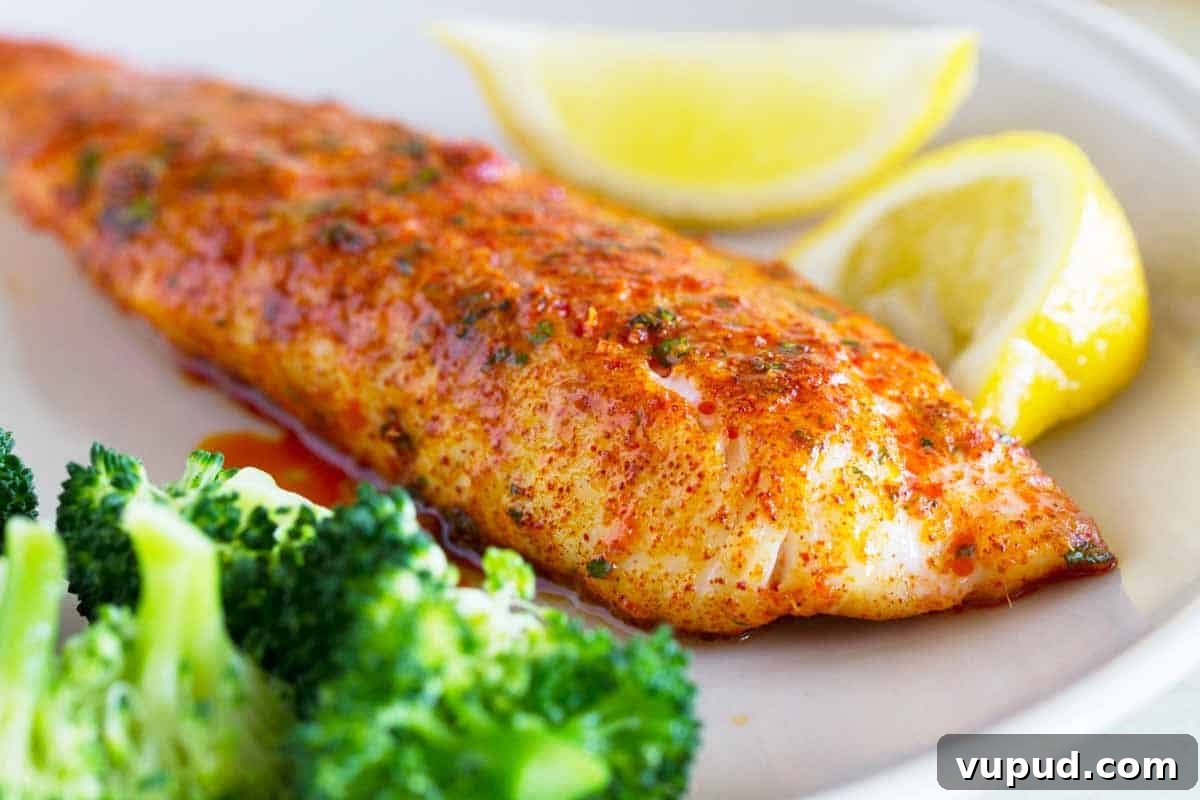 Parmesan Crusted Tilapia Parmesan Crusted Tilapia on a plate with lemons and broccoli
