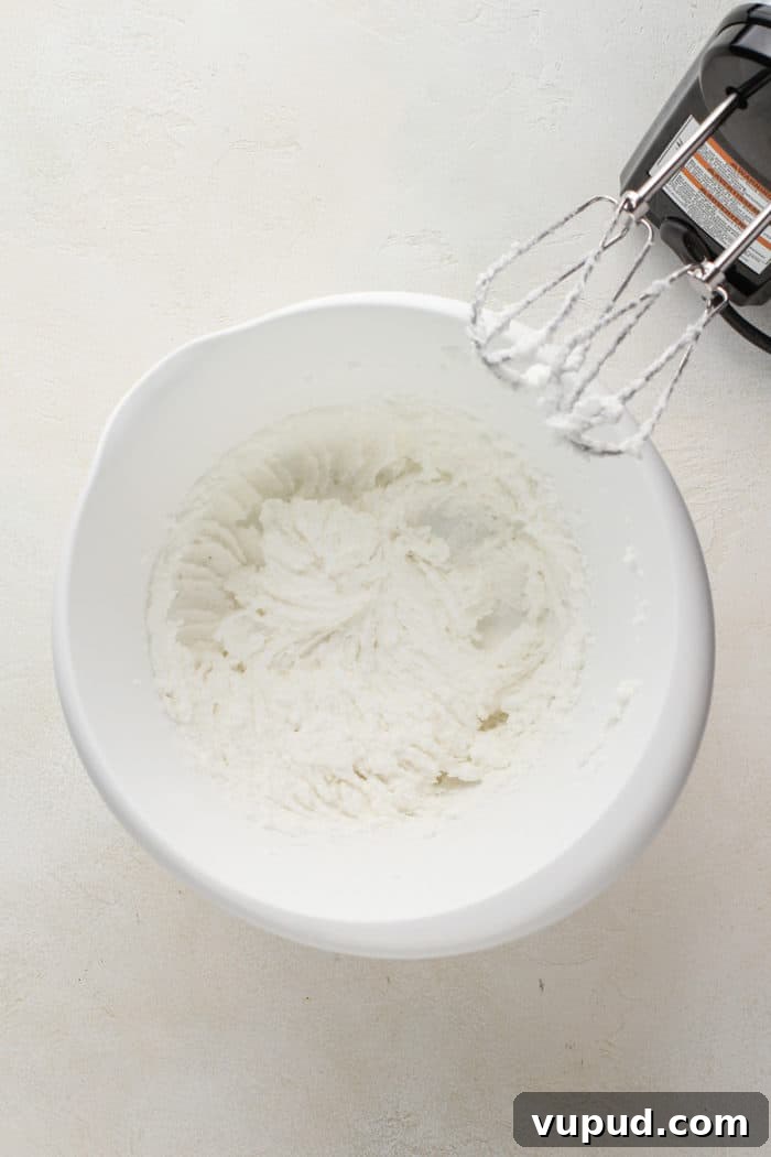 Decadent Date Cake Recipe with Warm Spices 5 Shortening and sugar creamed together in a white mixing bowl.